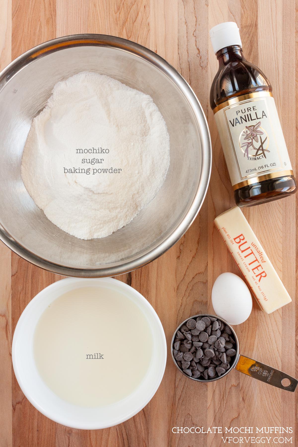 Ingredients for chocolate mochi muffins: mochiko, sugar, baking soda, evaporated milk, chocolate chips, unsalted butter, egg, and vanilla.